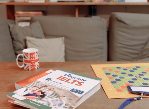 IELTS prep materials on a coffee table with a British flag mug and decor. Ideal for education themes.