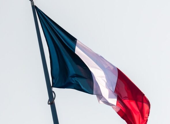 A red, white and blue flag flying in the wind